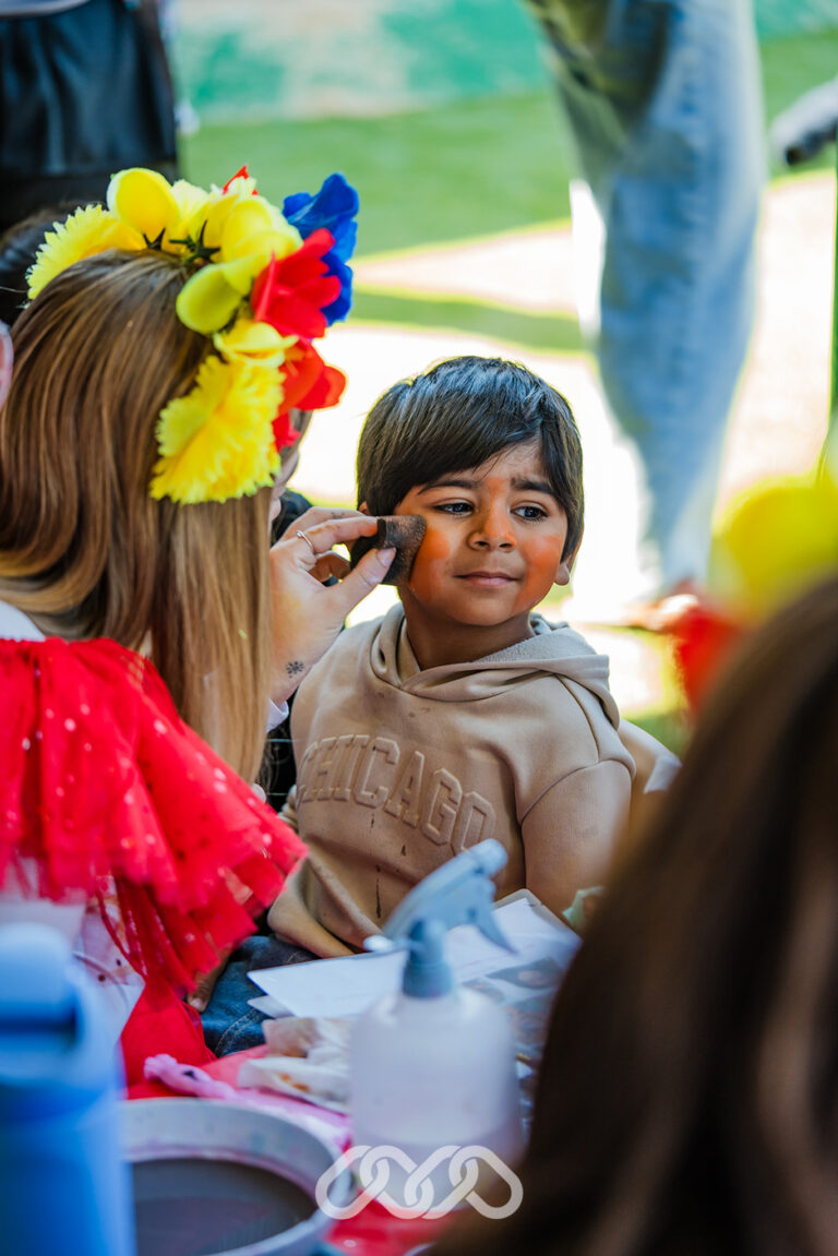 Child enjoying face painting at grand opening