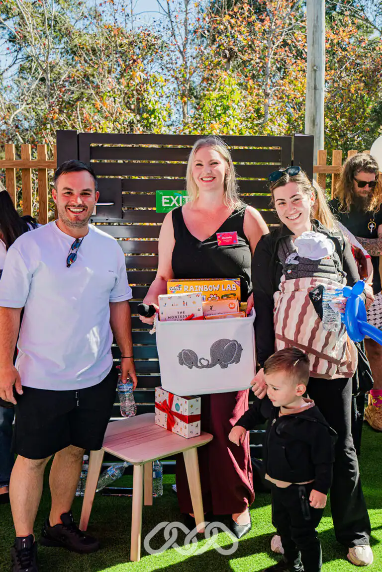 Family receiving a prize during the Northmead Montessori Academy Grand Opening celebrations.