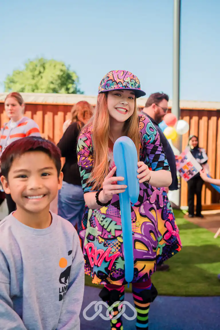Child enjoying balloon twisting at the Northmead Montessori Academy Grand Opening.