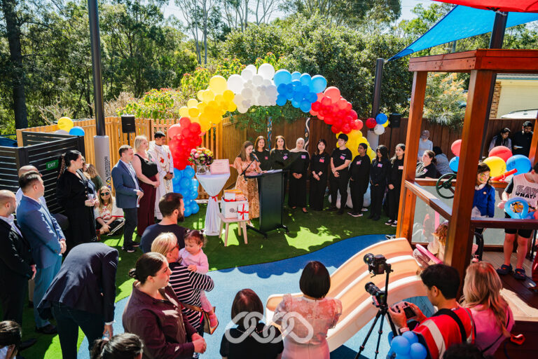 Leadership, families and Northmead team gathered outdoors under colourful balloons at the Northmead Montessori Academy Grand Opening.