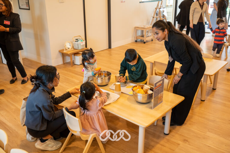 Families and children exploring Montessori activities inside Heidelberg West Montessori Academy.