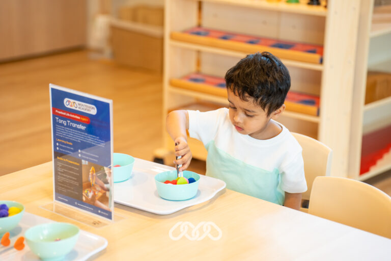 Young child exploring a hands-on Montessori activity inside Heidelberg West Montessori Academy.